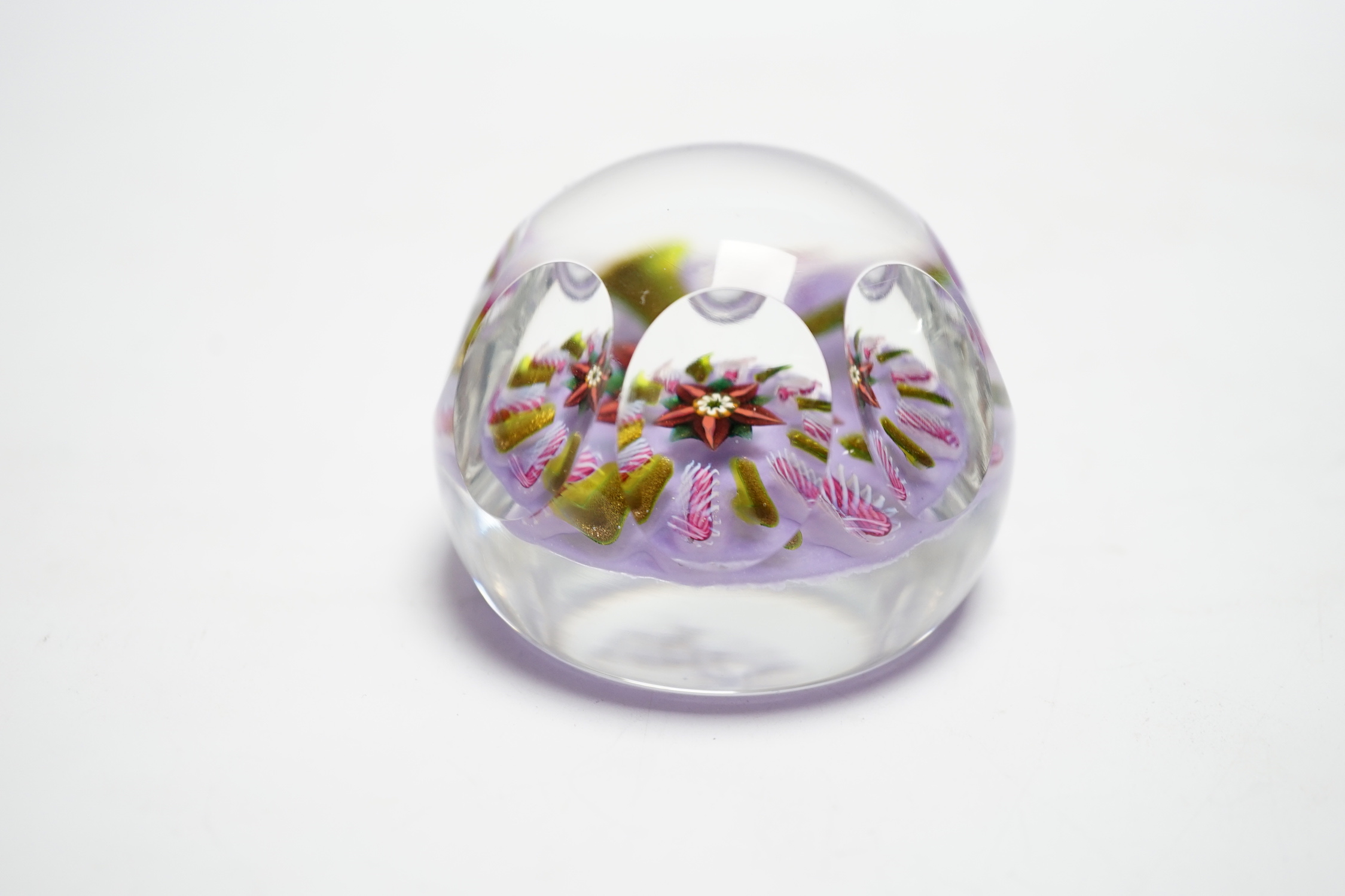 A Paul Ysart faceted ‘flower’ glass paperweight, Harland period, the central flower within aventurine and latticino spokes on a violet ground, PY paper label to base, 6.5cm